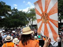 A protestor carries a sign calling for a "Gun Free UT", as they join others during a protest on campus in Austin, Texas, Wednesday Aug. 24, 2016. Hundreds of University of Texas students waved sex toys at a campus rally during the first day of classes, protesting a new state law that allows concealed handguns in college classrooms, buildings and dorms. (AP Photo/John Mone)