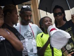 Samuel DuBose, a son of the deceased Samuel DuBose, speaks to the crowd during a demonstration outside the Hamilton County Courthouse after murder and manslaughter charges against University of Cincinnati Police Officer Ray Tensing were announced for the traffic stop shooting death of DuBose, Wednesday, July 29, 2015, in Cincinnati. (AP Photo/John Minchillo)