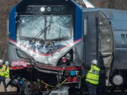 A National Transportation Safety Board staffer inspects the engine of Amtrak Train 89 which hit a construction vehicle on the tracks and derailed in Chester, Pa., Sunday, April 3, 2016. The train was heading from New York to Savannah, Ga. (Clem Murray/The Philadelphia Inquirer via AP)