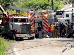 Emergency crews respond to a man trapped under an asphalt steam roller truck on Saunders Station Road in Monroeville, Pa. on Friday, Aug. 30, 2013. The man was operating the vehicle when he lost control of it and it rolled onto him. Police weren't immediately releasing details on the man or his condition. (AP Photo/Tribune Review, Lillian DeDomenic)