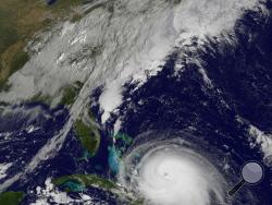 This satellite image taken Thursday, Oct. 1, 2015 at 9:37 a.m. EDT, and released by the National Oceanic and Atmospheric Administration (NOAA), shows Hurricane Joaquin. The powerful Category 4 hurricane pounded lightly populated islands of the eastern Bahamas on Thursday, and forecasters said it could grow more intense while following a path that would near the U.S. East Coast by the weekend. (NOAA via AP)