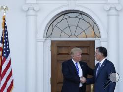 President-elect Donald Trump and Mitt Romney shake hands as Romney leaves Trump National Golf Club Bedminster in Bedminster, N.J., Saturday, Nov. 19, 2016. (AP Photo/Carolyn Kaster)