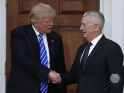 FILE - In this Nov. 19, 2016, file photo, President-elect Donald Trump shakes hands with retired Marine Corps Gen. James Mattis as he leaves Trump National Golf Club Bedminster clubhouse in Bedminster, N.J. Trump said at a rally on Dec. 1, that he will nominate Mattis as defense secretary. (AP Photo/Carolyn Kaster, File)