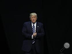 FILE- In this Dec. 9, 2016, file photo, President-elect Donald Trump arrives to speak to supporters during a rally, in Grand Rapids, Mich. Trump is facing an early test with fellow Republicans over U.S. relations with Russia. Lawmakers are seeking to investigate Russian interference in the November election and issue warnings over the incoming president's potential pick for secretary of state. (AP Photo/Paul Sancya, File)