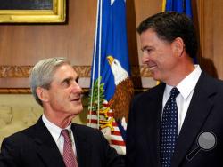 FILE - In this Sept. 4, 2013, file photo, then-incoming FBI Director James Comey talks with outgoing FBI Director Robert Mueller before Comey was officially sworn in at the Justice Department in Washington. On May 17, 2017, the Justice Department said it is appointing Mueller as special counsel to oversee investigation into Russian interference in the 2016 presidential election. (AP Photo/Susan Walsh, File)