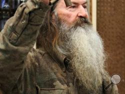 File-This Nov. 7, 2013 file photo shows Phil Robertson, the Duck Commander, holding the 1 millionth duck call assembled for 2013 at company’s warehouse in West Monroe, La. (AP Photo, The News-Star/Margaret Croft)