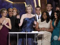 In this Jan. 23, 2010 file photo, Jane Lynch, center, and the cast of "Glee" accept the award for best ensemble in a comedy series at the 16th Annual Screen Actors Guild Awards in Los Angeles. (AP Photo/Mark J. Terrill)