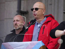 Co-owners of Club Q, Matthew Haynes, front, and Nic Grzecka, address the crowd after a 25-foot historic pride flag was displayed on the exterior of City Hall to mark the weekend mass shooting at the gay nightclub Wednesday, Nov. 23, 2022, in Colorado Springs, Colo. The flag, known as Section 93 of the Sea to Sea Flag, is on loan for two weeks to Colorado Springs from the Sacred Cloth Project. (AP Photo/David Zalubowski)