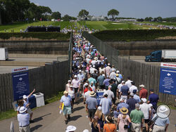 Fans use a pedestrian bridge over the Pennsylvania Turnpike, which divides Oakmont Country Club, during a practice round ahead of the U.S. Open golf tournament Wednesday, June 11, 2025, in Oakmont, Pa. (AP Photo/Carolyn Kaster)