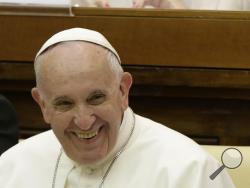 Pope Francis smiles as he arrives to attend a two-day summit of judges and magistrates against human trafficking and organized crime, at the Vatican, Friday, June 3, 2016. Judges and prosecutors from around the world are pledging to crack down on human trafficking and help victims of modern-day slavery in the latest Vatican initiative to draw attention to the problem and rally resources to fight it. (AP Photo/Gregorio Borgia)