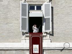 Pope Francis delivers his blessing during the Angelus noon prayer he celebrated from the window of his studio overlooking St. Peter's Square, at the Vatican, Sunday, Oct. 30, 2016. (AP Photo/Andrew Medichini)