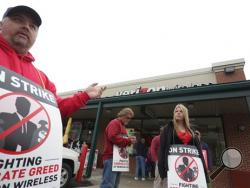 Union worker Kevin Potter of Pittston Township, a Verizon maintenance splicer, stands in front of a Verizon store in Dickson City, Pa., as he strikes with other Verizon employees and their supporters, Thursday, May 5, 2016. (Jake Danna Stevens/The Times-Tribune via AP) 