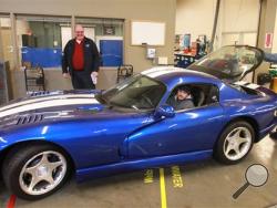 Automotive professors Tom Witt, left, and Norm Chapman supervise as advanced student Mike Murphy prepares to fire up the one-of-a-kind, $250,000 Dodge Viper SRT in the automotive shop at South Puget Sound Community College in Tumwater, Wash., on Tuesday, March 4, 2014. Chapman received notice Tuesday morning that Chrysler was ordering the entire collection of educational Vipers - believed to be about 93 cars worth tens of millions of dollars - to be crushed. (AP Photo/The Olympian, Tony Overman)