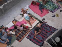 In this May 29, 2015 file photo, Indians sleep on the roof of a house to beat the heat in New Delhi, India. (AP Photo/Tsering Topgyal, File)