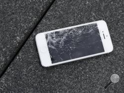 This Aug. 26, 2015 photo shows an Apple iPhone with a cracked screen after a drop test from the DropBot, a robot used to measure the sustainability of a phone to dropping, at the offices of SquareTrade in San Francisco. Despite engineering breakthroughs, screen breakage has become a part of life, the leading type of phone damage. (AP Photo/Ben Margot)