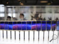 In this March 1, 2015 file photo, the new Galaxy S6 and S6 Edge phones are displayed during a Samsung Galaxy Unpacked 2015 event on the eve of the Mobile World Congress wireless show in Barcelona, Spain. (AP Photo/Manu Fernandez, File)