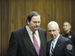 Bob Bashara, left, and his defense attorney Mike McCarthy enter the courtroom for the reading his verdict at the Frank Murphy Hall of Justice in Detroit on Thursday, Dec. 18, 2014. (AP Photo/The Detroit News, David Coates)