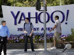FILE - In this June 5, 2014, file photo, people walk in front of a Yahoo sign at the company's headquarters in Sunnyvale, Calif. Yahoo says the personal information of 500 million accounts have been stolen in a massive security breakdown that represents the latest setback for the beleaguered internet company. The breach disclosed on Thursday, Sept. 22, 2016, dates back to late 2014. Yahoo is blaming the hack on a “state-sponsored actor.” (AP Photo/Marcio Jose Sanchez, File)
