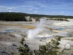 This September, 2009 file photo shows the Norris Geyser Basin in Yellowstone National Park, Wyo. Rangers are navigating a dangerous landscape where boiling water flows beneath a fragile rock crust as they search for a man who reportedly fell into a hot spring at Yellowstone National Park. Officials say the safety of park personnel was a top concern during the search in the popular Norris Geyser Basin. The man is presumed dead. (AP Photo/Beth Harpaz, File)