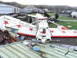 A high-wing airplane was tossed by the heavy winds that blew through the Benton area early Monday morning. The damaging winds tore apart the hanger for the plane, along with the Benton Borough maintenance shed at the airport. (Press Enterprise/Keith Haupt)