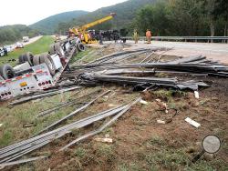 A tractor-trailer driver rolled his flatbed load of steel, closing down the eastbound lanes of Interstate 80 near the 249 mile marker in Nescopeck Township on Monday afternoon. According to State Police, witnesses saw another tractor trailer cut the driver off, causing him to lose control. (Press Enterprise/Jimmy May)