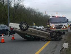 A Mercury sedan remains overturned after an accident Monday morning on Route 54 near Danville. (Press Enterprise/Julye Wemple)