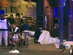 (AP Photo/Thibault Camus) Victims lay on the pavement in a Paris restaurant, Friday. Police have reported shootouts in at least two restaurants in Paris. At least two explosions have been heard near the Stade de France stadium, and French media is reporting of a hostage-taking in the capital. 