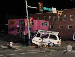 A van slammed into the traffic light at East and Seventh streets early Tuesday morning. (Press Enterprise/Mike Lester)