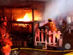 Firefighters battle a blaze at 522 Montour Blvd., Lot 2, early Sunday morning. (Press Enterprise/Leon Bogdan)