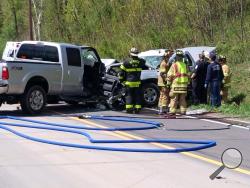 Rescue crews work to free occupants of two pickups that crashed on Route 11 on Tuesday. (Press Enterprise/Jimmy May)