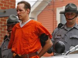 In this Oct. 31, 2014 file photo Eric Frein is escorted by police into the Pike County Courthouse for his arraignment in Milford, Pa. Frein was captured seven weeks after police say he killed a Pennsylvania State trooper in an ambush outside a barracks in northeastern Pennsylvania. (AP Photo/Rich Schultz, File)