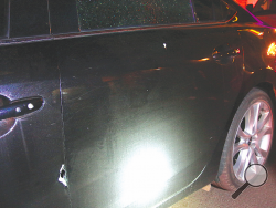 (Press Enterprise/M.J. Mahon) A bullet hole is shown on the driver door of Kahn’s car, as well as a second on the rear door Friday evening after someone shot into an occupied parked car.