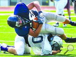 Central's Payton Aucher, top, is stopped by a G.A.R. defender during a scrimmage at BU.