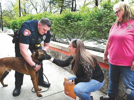 Commonwealth University-Bloomsburg staff passing by the university police station stop to meet the the new K9 dog, a one-year-old Belgian Malinois named Rush, on Wednesday. From left are police officer and handler Eli Middaugh, Emily Wolfe and Michelle Leiby. 