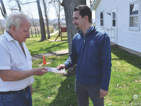 State Representative Robert Leadbeter, right, talks with Mark Ehmann outside of the Fishing Creek polling place at the St. James Community Hall along Zaner Bridge Road Tuesday afternoon. 