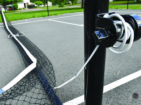 The cable holding up a next on the pickle ball court at the Scott School Park sits hanging on the post after it was cut by vandals early Thursday morning. 