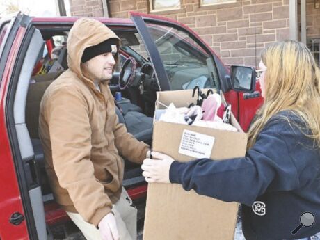 Chris Starr, at left, gets a box of items from Sydney Campbell Tuesday during the Bloomsburg Salvation Army's Angel Tree giveaway. Chris Starr, at left, gets a box of items from Sydney Campbell Tuesday during the Bloomsburg Salvation Army's Angel Tree giveaway.