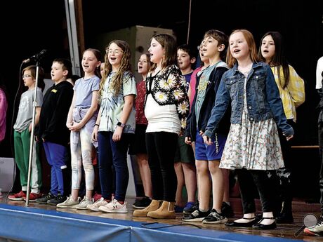 Nescopeck Elementary School fourth graders sing a version of “Take Me Home, Country Roads” by replacing original place names with Pennsylvania place names and landmarks such as the Susquehanna River during a spring music program for parents and fellow students on Wednesday
