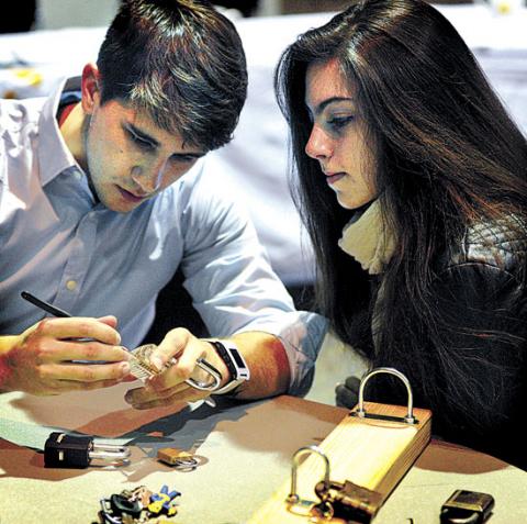 Bloomsburg University senior Rio Weber and Lehigh Carbon Community College student Kelsey Cicchetti work on picking a padlock in the Lock Pick Village event during BloomCON at Bloomsburg University on Friday. The two-day conference is hosted by the Bloomsburg University Digital Forensics Club. Bloomsburg University senior Rio Weber and Lehigh Carbon Community College student Kelsey Cicchetti work on picking a padlock in the Lock Pick Village event during BloomCON at Bloomsburg University on Friday. The two-day conference is hosted by the Bloomsburg University Digital Forensics Club.