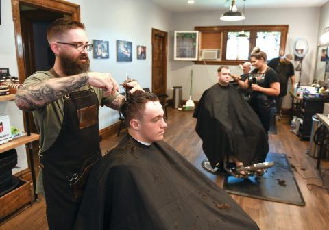 Brent Robinson of True Gents Barbershop Main Street Bloomsburg cuts the hair of Sebastian Price  of Berwick Friday afternoon.  The shop was able to open for business yesterday as Columbia County was placed in the green phase by Gov. Tom Wolf.