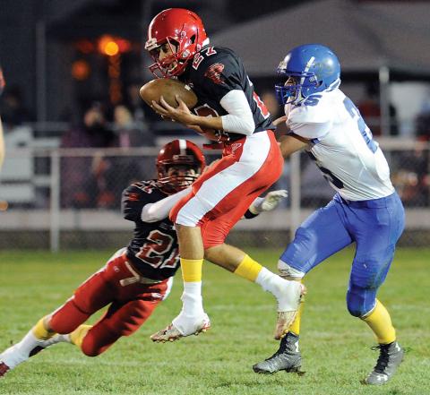 Mount Carmel’s Treyvon White, center, pulls in an interception intended for Warrior Run’s William Michael, right, as Mount Carmel’s Lane Tanney also dives into the play during the first quarter of Friday night’s game in Mount Carmel. Mount Carmel’s Treyvon White, center, pulls in an interception intended for Warrior Run’s William Michael, right, as Mount Carmel’s Lane Tanney also dives into the play during the first quarter of Friday night’s game in Mount Carmel.