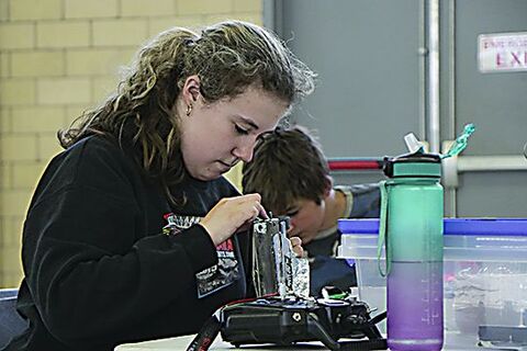 Josie Weible, 21, of Benton, a member of the Infectious Intelligence Combat Robot Club at the Bloomsburg Children’s Museum, repairs her robot, Poindexter, Saturday at the Battle in the Burg 2025 held in the Bloomsburg Fairgrounds’ Industrial Building. Josie Weible, 21, of Benton, a member of the Infectious Intelligence Combat Robot Club at the Bloomsburg Children’s Museum, repairs her robot, Poindexter, Saturday at the Battle in the Burg 2025 held in the Bloomsburg Fairgrounds’ Industrial Building.