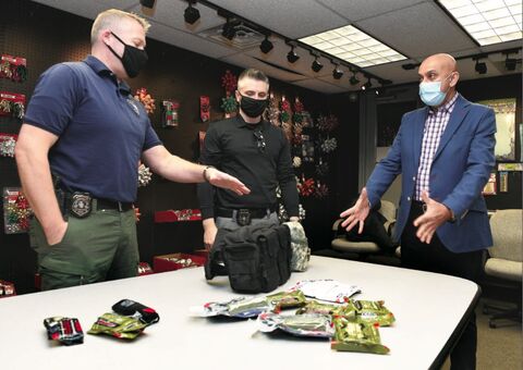 Berwick Police Detectives Greg Martin, left, and Reagan Rafferty talk with CSS Industries Senior Director of Manufacturing Rudy Singh at the plant on Bomboy Lane in Salem Township Tuesday morning. IG Design Group, owner of CSS and Berwick Offray, recently donated to the Berwick Police Benevolent Fund, which purchased trauma kits for police officers. The kits include tourniquets for hemorrhage control, chest injuries and trauma.