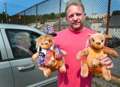 Trump supporter Ben Philips shows off stuffed animals he is selling outside his Bloomsburg apartment Wednesday afternoon.