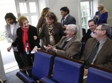In this Nov. 12, 2008 file photo veteran White House correspondent Helen Thomas is helped to her front row seat in the White House Brady Press Briefing Room in Washington, as she returned from an illness. Thomas, a pioneer for women in journalism and an irrepressible White House correspondent, has died. (AP Photo/Gerald Herbert)