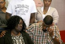 Odell Edwards wipes away tears as he sits with his wife, Charmaine Edwards, listening to their attorney Lee Merritt talking about the death of their son, Jordan Edwards, in a police shooting Saturday in Balch Springs, Texas, in Merritt's law office in Dallas, Monday, May 1, 2017. A suburban Dallas police chief said Monday that his department wrongly described why an officer fired into a moving vehicle and killed Jordan Edwards, after an attorney for the boy’s family said officers were trying to “justify the