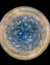  This image made available by NASA on Thursday, May 25, 2017, and made from data captured by the Juno spacecraft shows Jupiter's south pole. The oval features are cyclones, up to 600 miles (1,000 kilometers) in diameter. The cyclones are separate from Jupiter's trademark Great Red Spot, a raging hurricane-like storm south of the equator. The composite, enhanced color image was made from data on three separate orbits. (NASA/JPL-Caltech/SwRI/MSSS/Betsy Asher Hall/Gervasio Robles via AP)