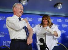 Health and Human Services Secretary Tom Price, left, is given a band-aid after a flu vaccination from Sharon Walsh-Bonadies, RN., right, during a news conference recommending everyone age six months an older be vaccinated against influenza each year, Thursday, Sept. 28, 2017 in Washington. (AP Photo/Pablo Martinez Monsivais)