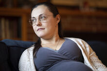 Alisha Alderson who is due to give birth in September, sits in the living room of her house in Baker City, Ore., on Thursday, Aug. 31, 2023. Because of the closing of Baker City's only obstetrical unit, the Anderson family is traveling to the Boise, Idaho area, a little over 100 miles away, to give birth. Alisha will be spending time with family in Kuna, Idaho for 3 weeks until she gives birth or is induced the third week of September. (AP Photo/Kyle Green)