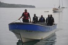 Jamaican Marine Police return to the Port Antonio Marina after a fruitless search for a plane that crashed into the ocean near Port Antonio, Jamaica, Friday, Sept. 5, 2014. (AP Photo/Everard Owen)